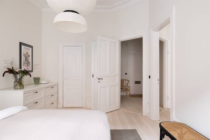 Bedroom with doorways to hall and living area